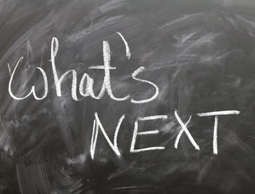 Picture of a blackboard with what's next written in white chalk